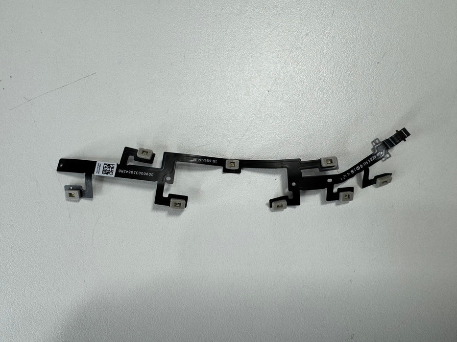 Closeup of a disconnected Meta Quest 2 controller sensor cable, showing the thin ribbon connector that links the tracking ring LEDs to the main circuit board.