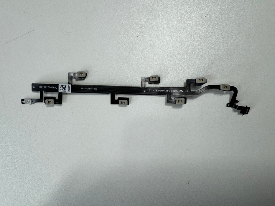 Closeup of a disconnected Meta Quest 2 controller sensor cable, showing the thin ribbon connector that links the tracking ring LEDs to the main circuit board.